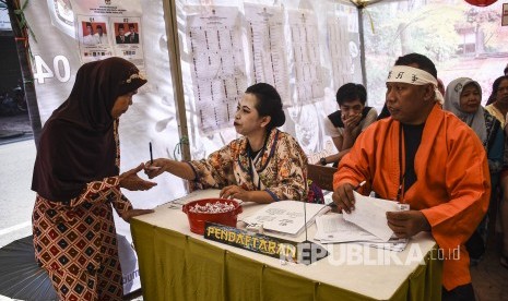 Polling station working committees (KPPS) of 2019 legislative and presidential election serving voters in TPS 004, Cibadak, Astanaanyar, Bandung City, West Java Province, April 17, 2019. 