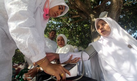 Ayat Alquran yang Mendukung Manasik Kesehatan Haji. Foto ilustrasi: Petugas medis pendamping memeriksa kesehatan Jamaah Calon Haji (JCH) yang mengikuti pemantapan manasik haji tahap akhir musim haji 2019 di Lhokseumawe, Aceh, Sabtu (29/6/2019). 