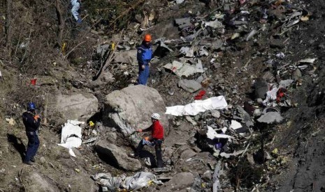 Petugas melakukan investigasi di lokasi jatuhnya pesawat Airbus A320 maskapai Germanwings di Seyne-les-Alpes, pegunungan Alpen, Prancis, Kamis (26/3).