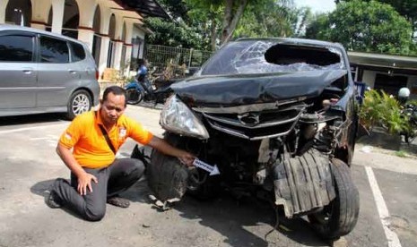 Petugas melakukan olah TKP terhadap mobil polisi yang ringsek akibat terjadi penembakan dua anggota Polri di Jalan Graha Raya, Tangerang, Banten, Sabtu (17/8).