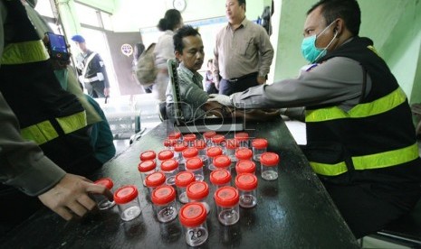  Petugas melakukan tes urine pengemudi bus antarkota dan antarprovinsi di Terminal Cicaheum, Bandung, Selasa (6/8).  (Republika/Edi Yusuf)