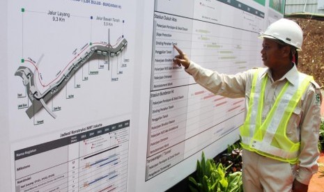  Petugas melihat jadwal pengerjaan MRT saat peletakan batu pertama pembangunan Stasiun MRT di Dukuh Atas, Jakarta, Kamis (10/10). (Republika/Yasin Habibi)