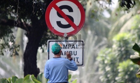  Petugas membersihkan dan menulis ulang rambu lalu lintas di jalan Medan Merdeka Selatan, Jakarta Pusat, Rabu (28/8).  (Republika/Yasin Habibi)