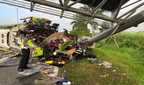 Petugas memeriksa bagian bus Ardiansyah yang mengalami kecelakaan tunggal di tol Mojokerto.