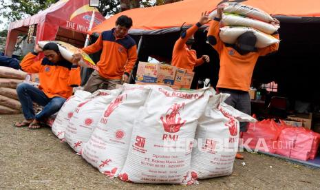 Petugas memindahkan paket sembako bantuan PT. RMI-Mitrphol Group di Posko Utama Penanganan Banjir Bandang di Kota Batu, Jawa Timur, Selasa (9/11/2021). Bantuan sembako tersebut diharapkan dapat bermanfaat dan meringankan beban masyarakat serta korban yang terdampak dari bencana alam banjir bandang di wilayah Kota Batu. 