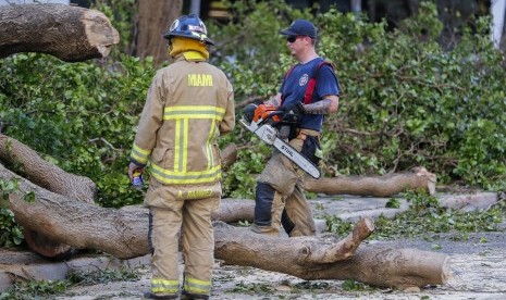 Petugas memotong batang pohon pascabadai Irmai di Miami, Amerika Serikat.