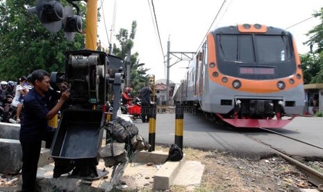 Petugas memperbaiki palang pintu kereta api di Grogol, Jakarta Barat, Senin (1/9). (Republika/ Yasin Habibi)