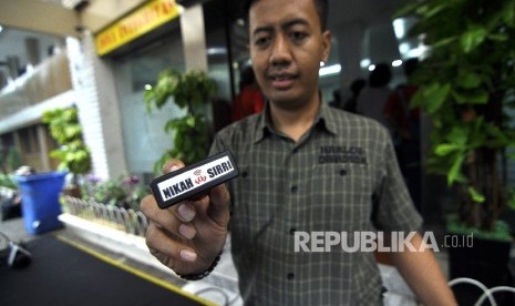 Police officer showed a stamp during an expose on the nikahsirri.com criminal case at Jakarta Metro Police, Sunday (September 24).