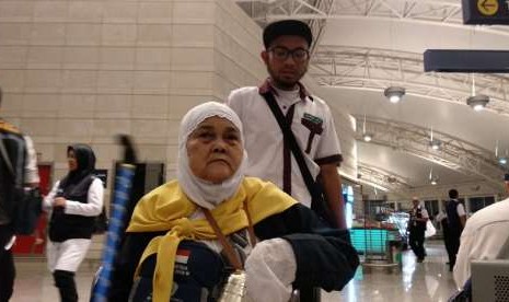 Petugas mendorong jamaah Kloter 41 Embarkasi Jakarta-Bekasi di Bandara Amir Muhammad bin Abdulaziz, Madinah, Ahad (9/9) dini hari. Kloter tersebut merupakan rombongan pertama yang bertolak pulang dalam gelombang kedua kepulangan jamaah haji.