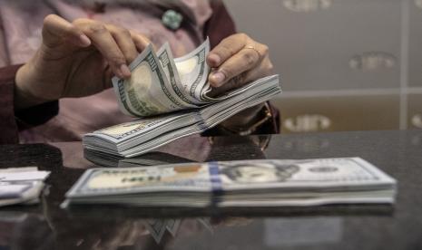 Petugas menghitung uang pecahan dolar AS di gerai penukaran mata uang asing VIP (Valuta Inti Prima) Money Changer, Jakarta, Selasa (4/10/2022). Nilai tukar rupiah terhadap dolar AS yang ditransaksikan antarbank di Jakarta pada Rabu menurun setelah rilis data inflasi Amerika Serikat (AS).