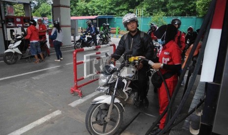 Petugas mengisi bahan bakar jenis premium di salah satu Stasiun Pengisian Bahan Bakar Umum (SPBU) di Jakarta, Rabu (30/12).