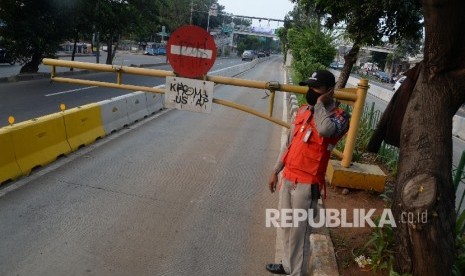 Petugas menjaga palang pintu jalur TransJakarta di Jalan Pramuka, Jakarta, Ahad (12/6).  (Republika/Yasin Habibi)