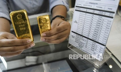 Petugas menunjukkan emas milik PT Aneka Tambang (Antam)