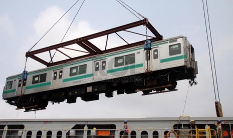 Petugas menurunkan salah satu unit KRL bekas dari Jepang saat tiba di Pelabuhan Tanjung Priok, Jakarta Utara, Senin (17/3). (Republika/Yasin Habibi)