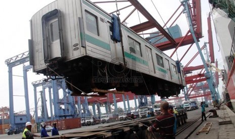 Petugas menurunkan salah satu unit KRL bekas dari Jepang saat tiba di Pelabuhan Tanjung Priok, Jakarta Utara, Senin (17/3). (Republika/Yasin Habibi)