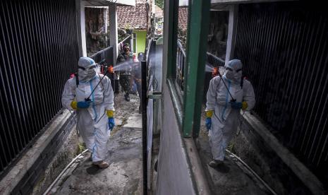 Petugas menyemprotkan cairan disinfektan di area permukiman warga di Cigending, Kecamatan Ujung Berung, Kota Bandung.