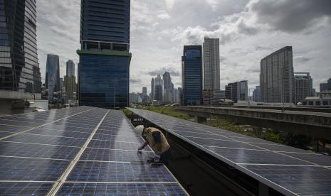 Petugas merawat panel surya yang terpasang di atap Gedung Direktorat Jenderal (Dirjen) Ketenagalistrikan Kementerian Energi dan Sumber Daya Mineral (EDSM), Jakarta, Rabu (24/3). Presiden Joko Widodo (Jokowi) kembali menekankan pentingnya pembangunan ke arah green economy. 