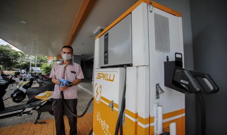 Petugas pelayanan menunjukkan cara pengisian daya untuk kendaraan bermotor listrik di Stasiun Pengisian Kendaraan Listrik Umum (SPKLU), (ilustrasi).