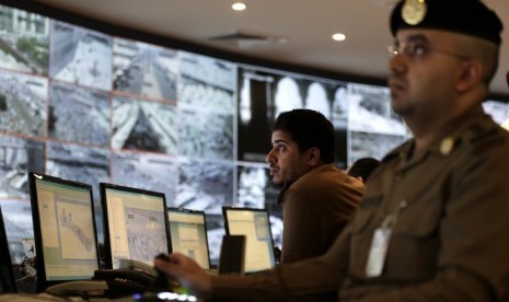  Petugas polisi Arab Saudi memantau melalui layar tv yang terhubung ke sejumlah kamera cctv yang dipasang di berbagai sudut kota Mina, Sabtu (27/10).  (Hassan Ammar/AP)