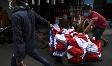 Petugas RT setempat membawa paket bantuan sosial dari pemerintah untuk disalurkan ke warga di kawasan Koja, Jakarta, Sabtu (2/5/2020). Kementerian Sosial akan menyalurkan 1,8 juta paket bantuan Khusus Presiden ke masyarakat di wilayah Jakarta, Bogor, Depok, Tangerang, dan Bekasi (Jabodetabek).