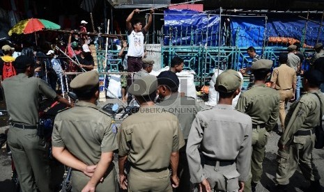 Petugas Satpol PP menertibkan pedagang di trotoar Pasar Senen, Jakarta Pusat, Rabu (21/1). ( Republika/Raisan Al Farisi)