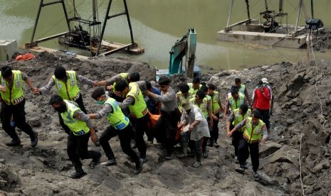 Petugas Tim SAR Gabungan mengevakuasi jenazah, Alun (50), yang tertimbun longsor di lokasi pertambangan pasir Desa Titisan, Kecamatan Sukalarang, Sukabumi, Jawa Barat, Senin (5/9). 