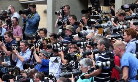 Photographers take pictures of The Duchess of Cambridge's parents Carole and Michael Middleton as they arrive at the Lindo Wing of St Mary's Hospital in London, to meet their new grandson Tuesday, July 23, 2013.