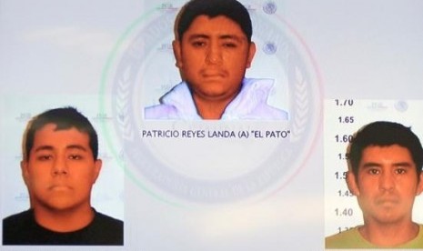 Pictures of the detainees for the case of missing students of Ayotzinapa are seen displayed on a television screen during a news conference at the Attorney General's Office building in Mexico City in this November 7, 2014, handout courtesy of the office.