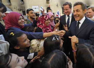 PM Inggris David Cameron (dua kanan) dan Presiden Prancis Nicolas Sarkozy (kanan) mendapat sambutan hangat saat berkunjung ke Libya.