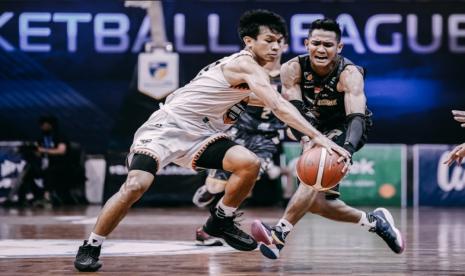 Point guard Bima Perkasa Jogja Azzaryan Pradhitya (kanan) membawa bola berusaha direbut pemain NSH Mountain Gold Jan Misael Panagan.