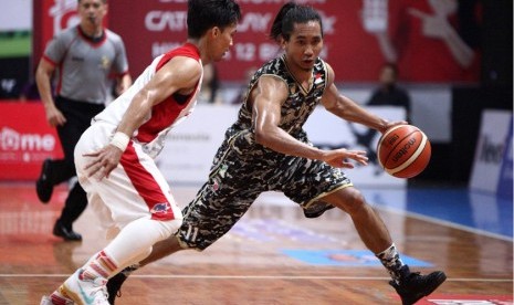 Point guard CLS Knights Arif Hidayat membawa bola berusaha melewati guard Bank BJB Garuda Bandung dalam laga play-off IBL Pertalite di GOL Kertajaya, Surabaya, Sabtu (1/4).