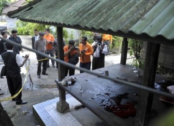 Police investigate the crime scene where five suspected terrorists killed in Denpasar, Bali, on Monday. 