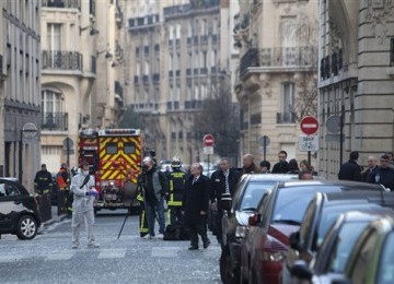 Police officers work on the site of a bomb explosion near the Indonesian Embassy in Paris, Wednesday, March 21, 2012. A Paris police official said an employee at the embassy discovered a suspicious package and stepped back in time before exploded. There wa