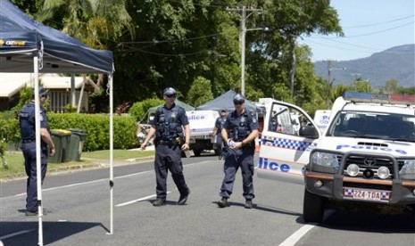 Police patrol near a house where eight children have been found dead in a Cairns suburb in far north Queensland, Australia, Friday Dec 19, 2014. 