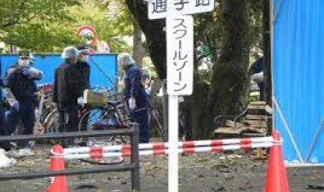 Policemen investigate an explosion site at a park in Utsunomiya on October 23, 2016.