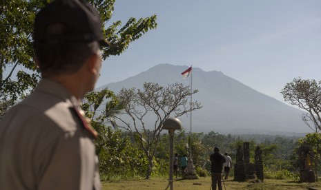 Polisi dan warga memantau aktifitas Gunung Agung di Pos Pemantauan Desa Rendang, Karangasem, Bali, Jumat (15/9).