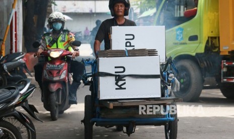 Polisi mengawal tukang becak yang mengangkut logistik hasil Pemilu 2019 di Jalan Tambak Sari, Surabaya, Jawa Timur, Kamis (18/4/2019).