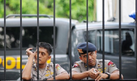 Polisi menjaga gerbang Gedung Komisi Pemberantasan Korupsi di Jakarta, Selasa (22/7). 