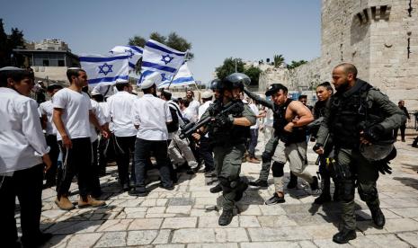 Polisi Perbatasan Israel menahan seorang warga Palestina saat bentrokan saat pawai bendera dekat Gerbang Damaskus di Kota Tua Yerusalem, 29 Mei 2022. 40 Warga Palestina Terluka Saat Pawai Bendera Israel