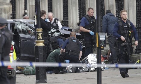 Polisi sedang mengevakuasi salah satu korban serangan Westiminster Bridge, London