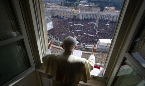 Pope Benedict XVI delivers his blessing during his last Angelus noon prayer, from the window of his studio overlooking St. Peter's Square, at the Vatican, Sunday.