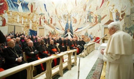 Pope Benedict XVI (right) delivers his message concluding a weeklong spiritual retreat, at the Vatican, Saturday, Feb. 23, 2013. 