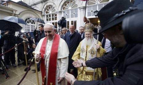 Pope Francis, left, and Ecumenical Patriarch Bartholomew I leave the Patriarchal Church of St. George after a holy liturgy in Istanbul, Sunday, Nov. 30, 2014. 