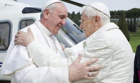 Pope Francis (left) embraces Pope Emeritus Benedict XVI as he arrives at the Castel Gandolfo summer residence March 23, 2013. 