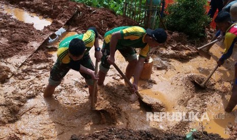 Prajurit Yonif Raider 323 Kostrad membantu korban bencana alam banjir dan tanah longsor di Pangandaran.