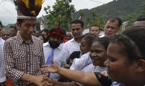 Preidential candidate, Joko Widodo (left) arrives in Yoka, Papua, on Thursday. 