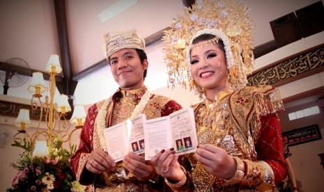 Presenter, komedian yang juga mantan personil kelompok musik Club Eighties Desta bersama bintang sinetron Natsha Rizki memperlihatkan buku nikah usai melangsung akad nikah di Masjid Bintaro, Tangerang Selatan, Minggu, (21/4). 