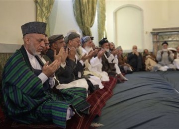 Presiden Afghanistan, Hamid Karzai (kiri), berdoa saat upacara pemakaman mantan Presiden Burhanuddin Rabbani di masjid Istana Kepresidenan di Kabul, Afghanistan (24/9).