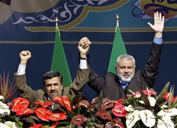 Presiden Iran, Mahmoud Ahmadinejad (kiri), dan Perdana Menteri Hamas, Ismail Haniyeh, mengepalkan salam persaudaraan dalam acara perayaan Revolusi Islam Iran ke-33 di Teheran, Sabtu (11/2). 