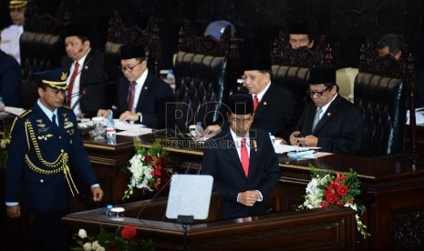  Presiden Joko Widodo berjalan menuju mimbar untuk memberikan pidato kenegaraan pertamanya dalam Sidang Tahunan MPR Tahun 2015 di Kompleks Parlemen, Senayan, Jakarta, Jumat (14/8).  (Republika/Raisan Al Farisi)